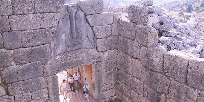 The Lion Gate archway with visitors passing through
