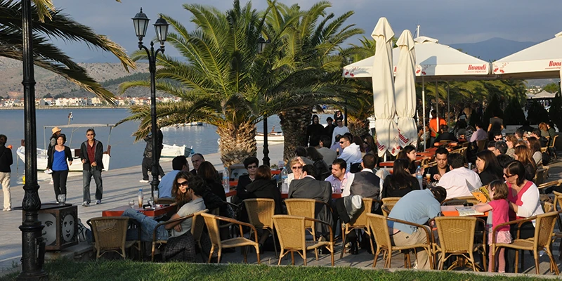 Waterfront cafes crowded with people in Nafplion