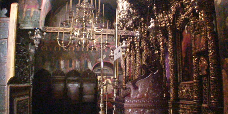 Candlelit Byzantine interior of the Monastery of St. John