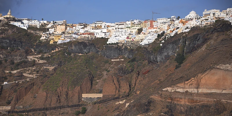 The town spilling down the red volcanic cliffs of Santorini