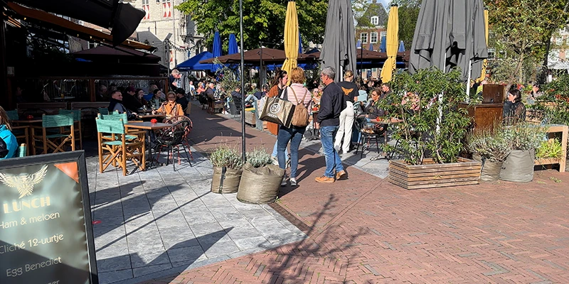 A busy café terrace crowd on a square in Middelburg