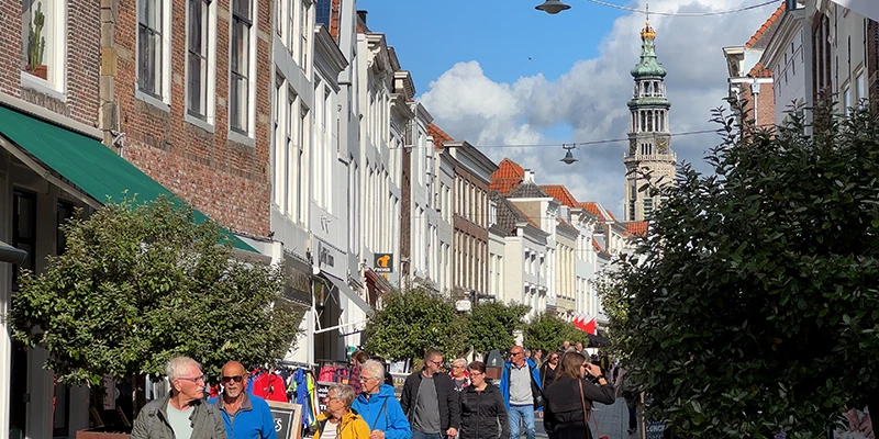 A pedestrian shopping street in Middelburg lined with historic houses
