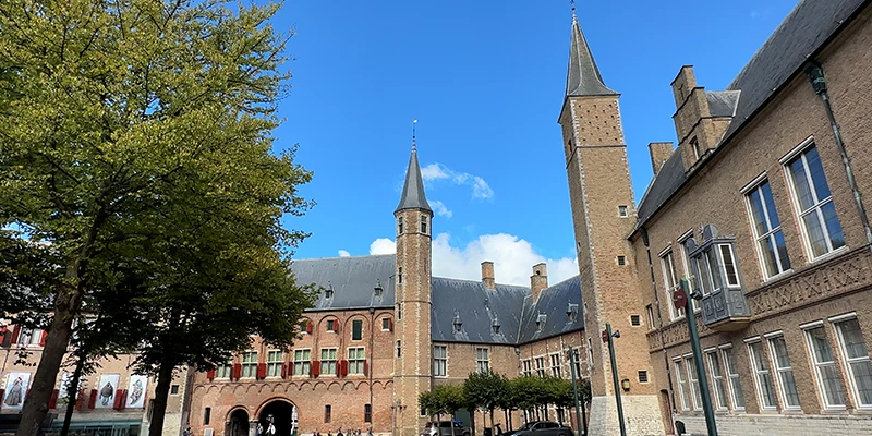 The tree-shaded abbey square in Middelburg with the museum buildings