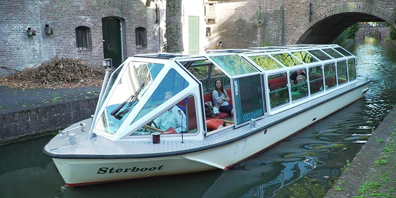 New canal boat under bridge